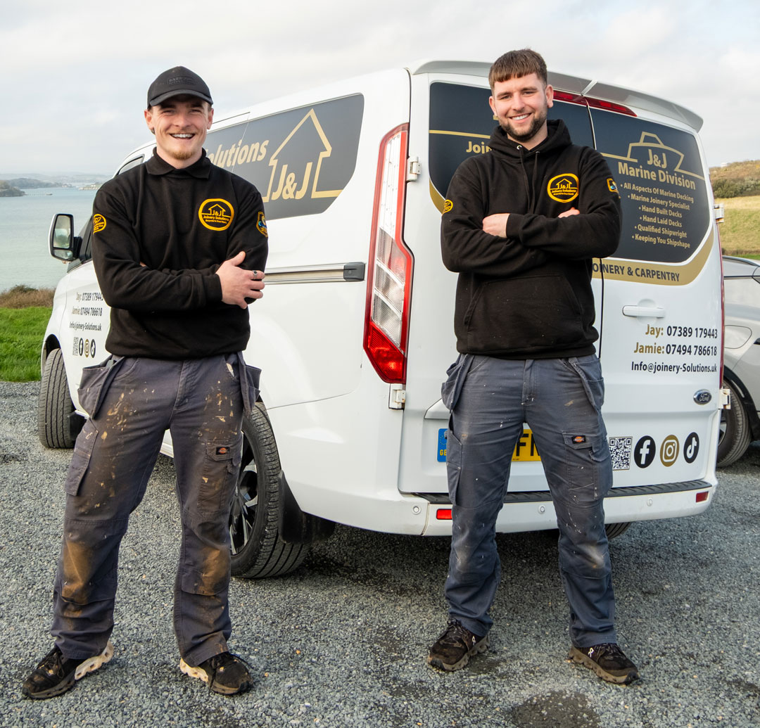 J&J standing in frnot of the Van